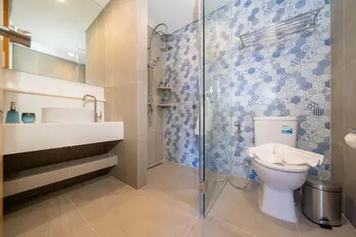 a bathroom with a toilet and a glass shower at New 1 br studio in Laguna Phuket in Phuket Town