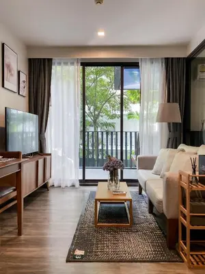 a living room with a couch and a table at The Deck condominium Patong beach in Patong Beach