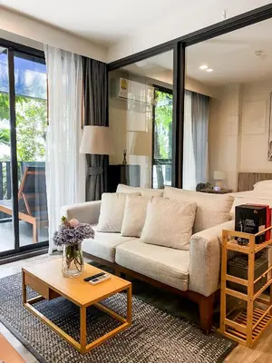 a living room with a couch and a table at The Deck condominium Patong beach in Patong Beach