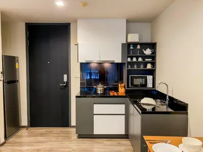 a kitchen with white cabinets and a black counter top at The Deck condominium Patong beach in Patong Beach