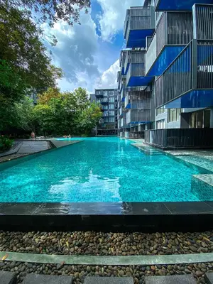 a swimming pool in front of a building at The Deck condominium Patong beach in Patong Beach