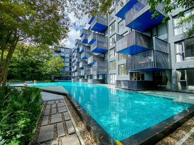 an apartment building with a large swimming pool at The Deck condominium Patong beach in Patong Beach