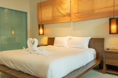 a bedroom with a bed with two swans on it at Oxygen 3BR Walk to Shops, Bars, Private Pool v113 in Rawai Beach