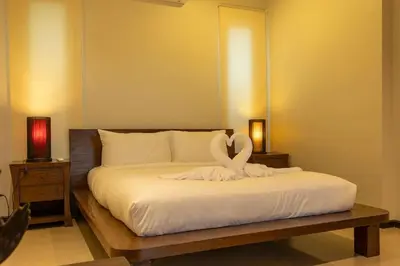 a bedroom with a bed with a swan statue on it at Oxygen 3BR Walk to Shops, Bars, Private Pool v113 in Rawai Beach