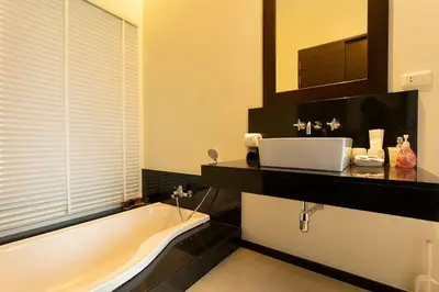 a bathroom with a tub and a sink and a mirror at Oxygen 3BR Walk to Shops, Bars, Private Pool v113 in Rawai Beach