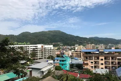 a city with buildings and mountains in the background at EMERALD TERRACE CONDO 52-FAMILY 1 Bedroom POOL VIEW in Patong Beach