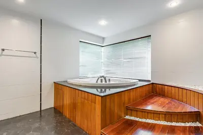 a bathroom with a tub and a window at Villa Suriya B2 in Patong Beach