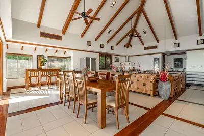 a kitchen and dining room with a wooden table and chairs at Villa Suriya B2 in Patong Beach
