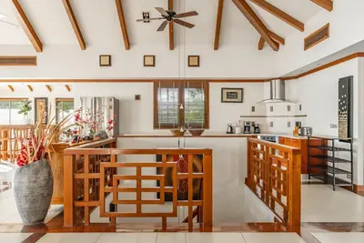 a kitchen with wooden furniture and a ceiling at Villa Suriya B2 in Patong Beach