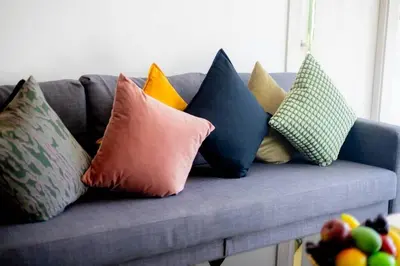 a bunch of pillows sitting on a blue couch at Pool Villa No 10 by Duangtham in Ban Khlong Haeng