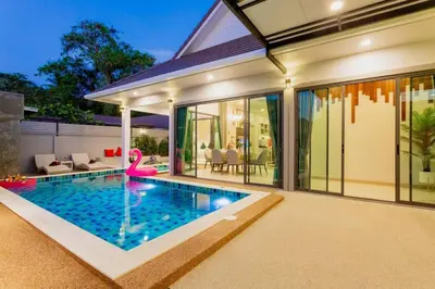 a swimming pool in the backyard of a house at Pool Villa No 10 by Duangtham in Ban Khlong Haeng