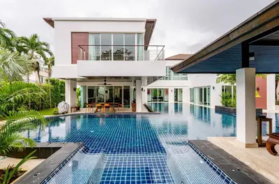a swimming pool in front of a villa at Kyerra 88-16 An exquisite mansion with eclectic interiors in Phuket Town