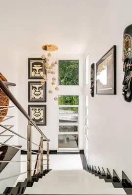 a hallway with black and white stairs and a window at Kyerra 88-16 An exquisite mansion with eclectic interiors in Phuket Town