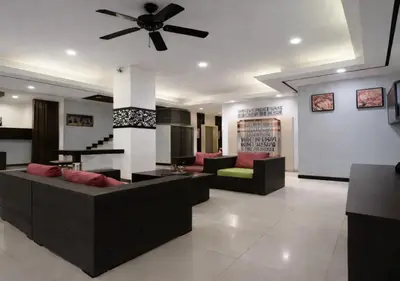 a living room with couches and a ceiling fan at The Star House in Patong Beach