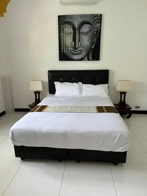 a large bed in a room with two lamps at Villa Happy home in Rawai Beach
