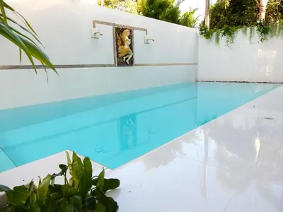 a swimming pool with a picture of a woman on the wall at Villa Happy home in Rawai Beach