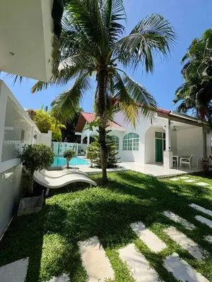 a palm tree in the yard of a house at Villa Happy home in Rawai Beach