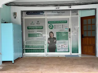 a wall with a poster of a woman on it at Best Rent a Room in Nai Yang Beach