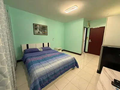 a bedroom with a bed and a flat screen tv at Best Rent a Room in Nai Yang Beach