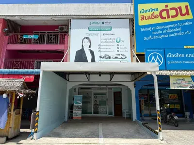 a building with a large sign in front of it at Best Rent a Room in Nai Yang Beach