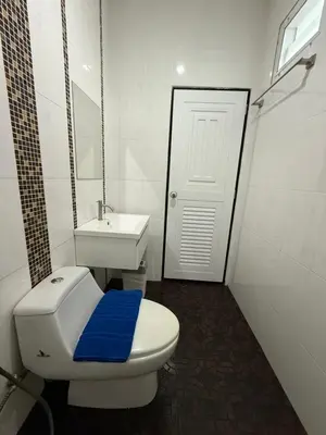 a bathroom with a white toilet and a sink at Best Rent a Room in Nai Yang Beach