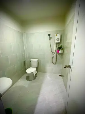 a bathroom with a toilet and a shower at Da Airport Hotel in Nai Yang Beach