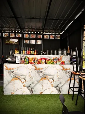 a bar with a marble counter in a room at Da Airport Hotel in Nai Yang Beach