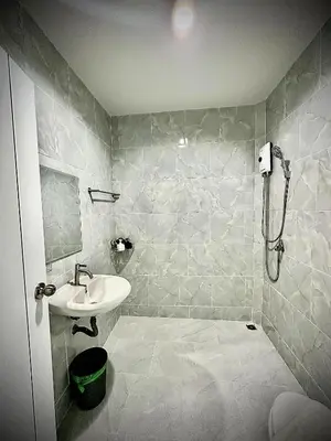 a bathroom with a sink and a shower at Da Airport Hotel in Nai Yang Beach