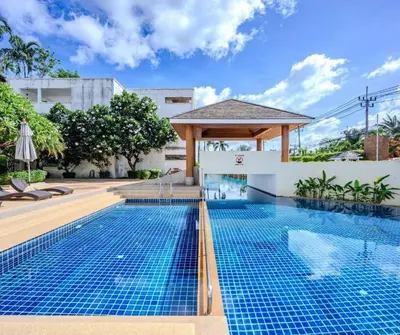a pool with a gazebo next to a building at Modern Condo near the Beach - NV531 in Phuket Town
