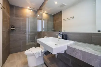 a bathroom with a white sink and a toilet at Modern Condo near the Beach - NV531 in Phuket Town
