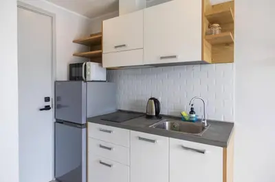 a kitchen with a sink and a refrigerator at Modern Condo near the Beach - NV531 in Phuket Town