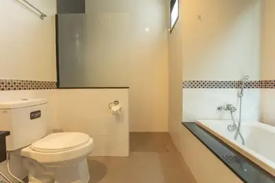 a bathroom with a toilet and a sink and a tub at 2 Beds large pool night market Soi Namjai v122 in Rawai Beach