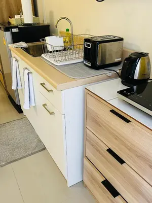 a kitchen with a counter with a sink and a toaster at Studio Room with private kitchen and Bathroom in Ban Phlu Yai