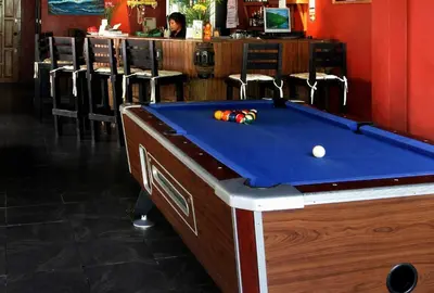 a pool table in a bar with a pool ball on it at Karon Pool Hotel in Karon Beach