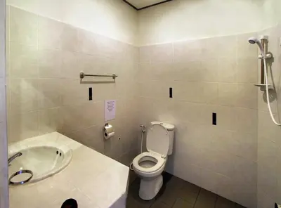 a bathroom with a toilet and a sink at Karon Pool Hotel in Karon Beach