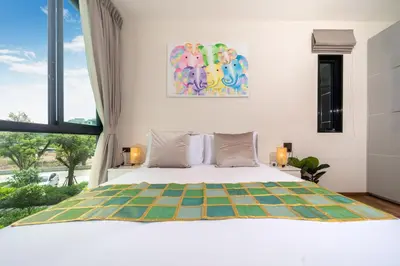 a bedroom with a bed and a large window at The Halo 1 Naiyang Beach in Nai Yang Beach