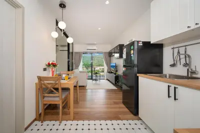 a kitchen and living room with a table and a sink at The Halo 1 Naiyang Beach in Nai Yang Beach