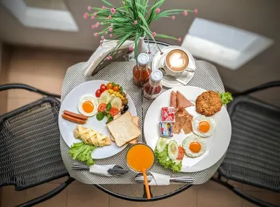 two plates of breakfast food on a table at Heaven House Restro & Bar in Patong Beach