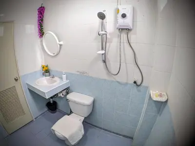 a bathroom with a shower and a toilet and a sink at Heaven House Restro & Bar in Patong Beach