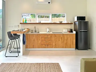 a kitchen with a stainless steel refrigerator and a counter at At the Beach New comfortable Pool Home, Ao Yon Beach, Phuket in Ban Ao Makham