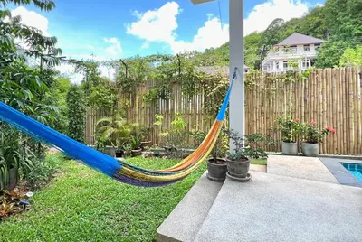 a blue and yellow hammock in a yard at At the Beach New comfortable Pool Home, Ao Yon Beach, Phuket in Ban Ao Makham
