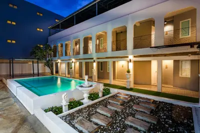 a swimming pool in front of a building at The Light House at Town Phuket in Phuket Town