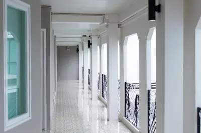 a hallway with paintings on the walls of a building at The Light House at Town Phuket in Phuket Town