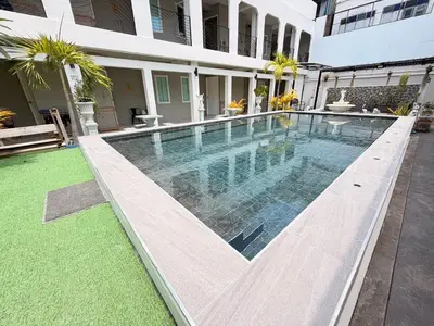 a swimming pool in front of a building at The Light House at Town Phuket in Phuket Town