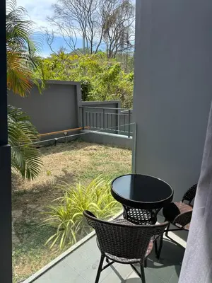 a patio with a table and chairs on a balcony at Duplex apartment on Naiharn Beach A22 in Rawai Beach