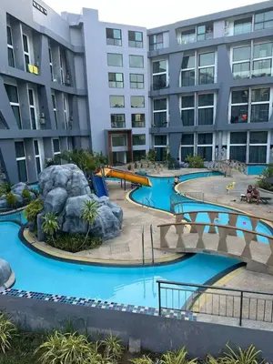 a water park in front of a building at Duplex apartment on Naiharn Beach A22 in Rawai Beach