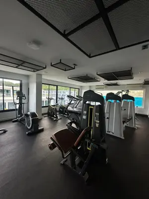 a gym with treadmills and cardio equipment in a building at Duplex apartment on Naiharn Beach A22 in Rawai Beach