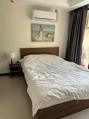 a bedroom with a bed with a painting on the wall at Nai Harn Beach Condo (P1) in Rawai Beach
