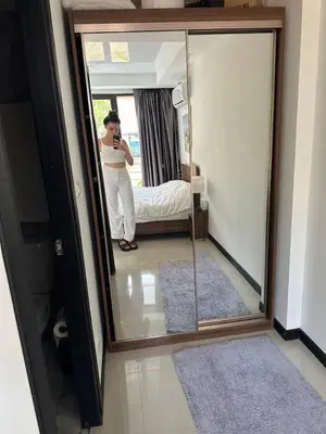 a woman taking a picture of herself in a mirror at Nai Harn Beach Condo (P1) in Rawai Beach