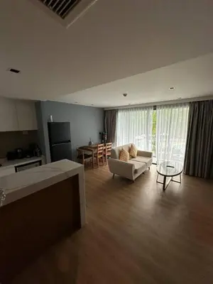 a living room with a couch and a table at Spacious apartment 600m from the beach in Rawai Beach